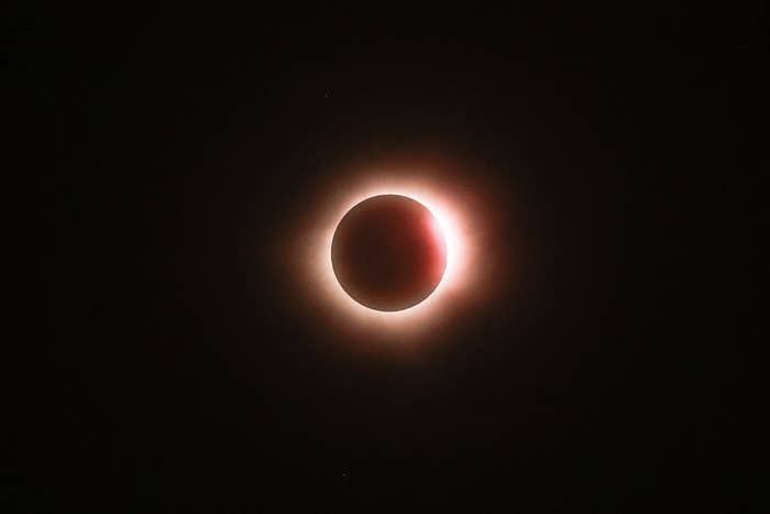 Total solar eclipse with the moon obscuring the sun and a halo of light visible