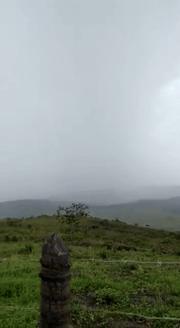 GIF of a person standing close to a lightning strike