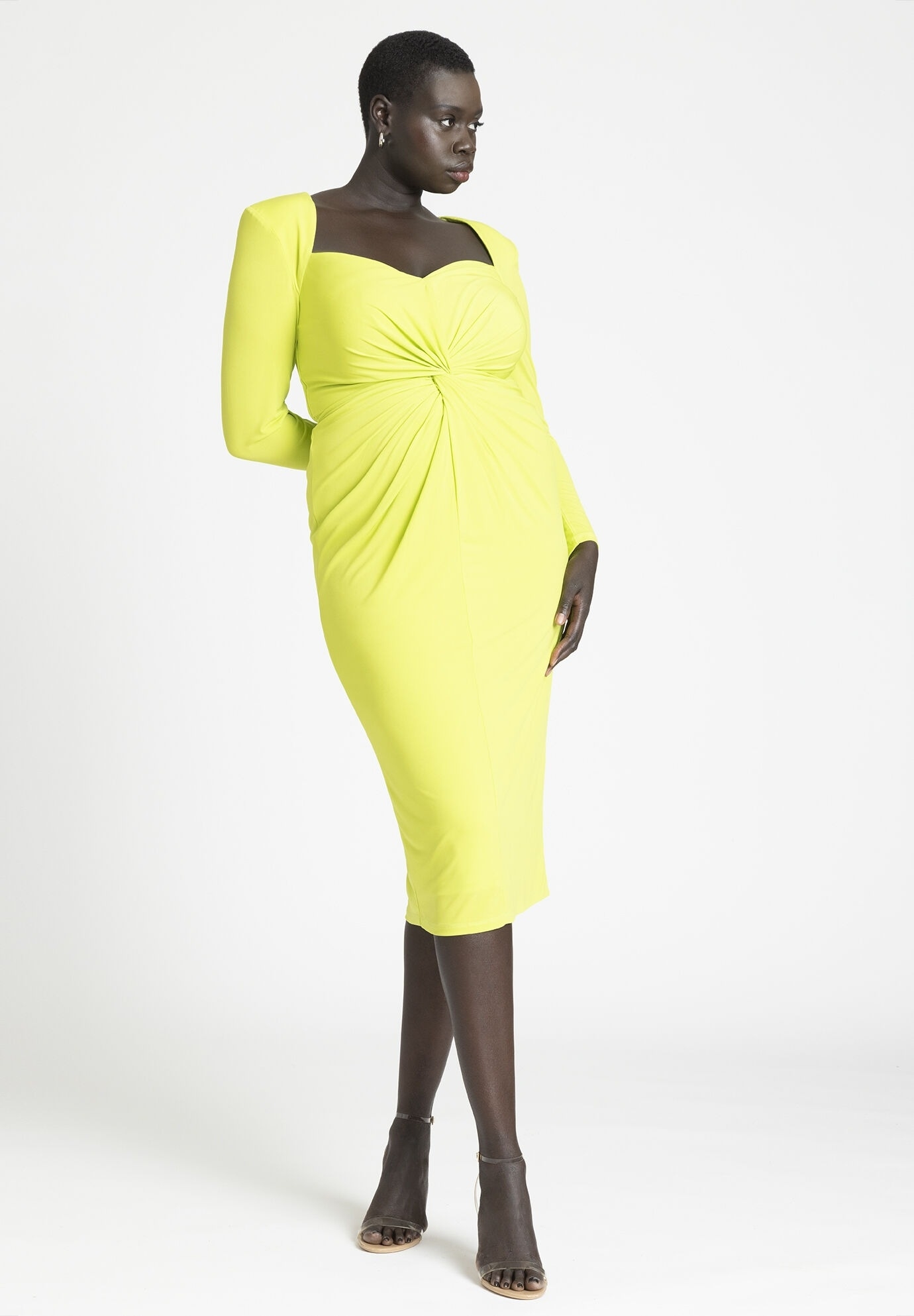 model posing in a stylish bright yellow twist-front knee-length dress with long sleeves