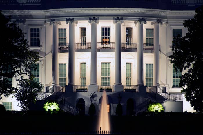 Nighttime view of the illuminated White House facade