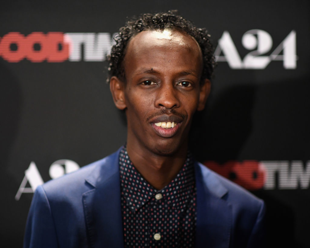 Barkhad in a patterned shirt and blue blazer smiling at a Good Time event