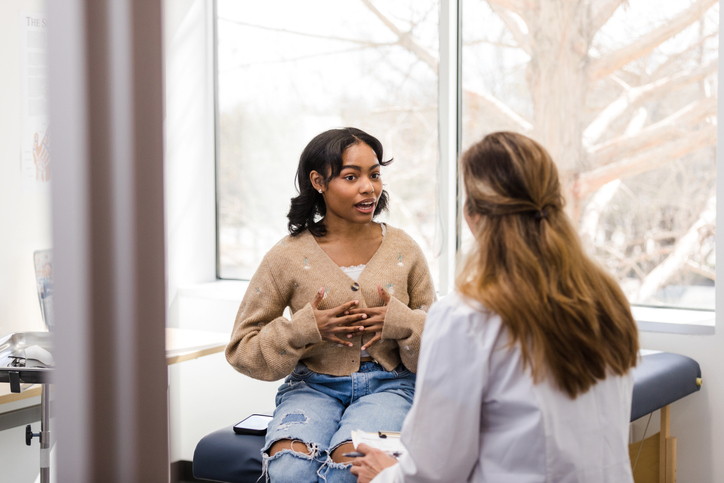 Patient having a conversation with a healthcare provider in a medical office