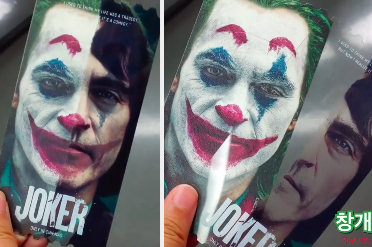 Movie promotion card for &quot;Joker&quot; with image of character&#x27;s face partially covered by a flap revealing actor&#x27;s face beneath