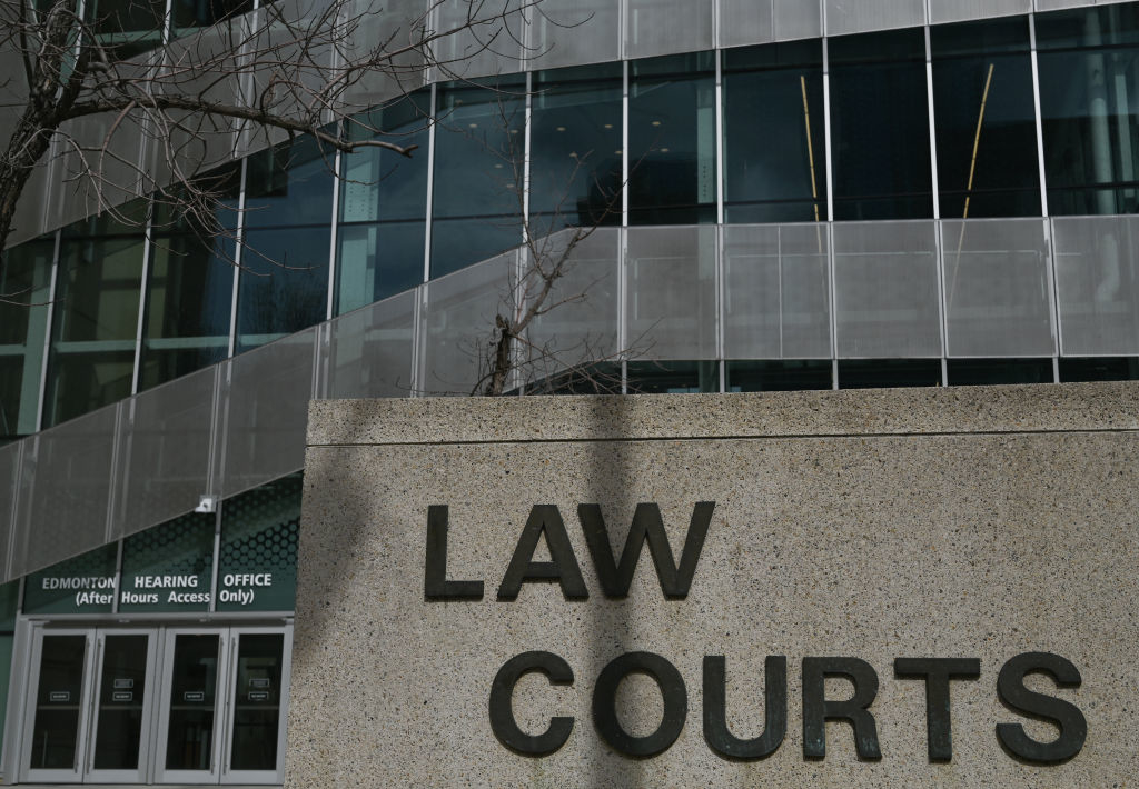 Exterior view of a building with &quot;LAW COURTS&quot; sign in the foreground