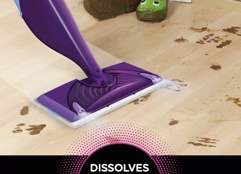 A mop cleaning a messy floor with the text &quot;Dissolves Tough Messes&quot; indicating its cleaning power