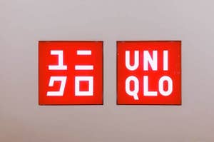 Two Uniqlo store logos displayed side by side on a wall