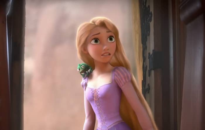 Animated character Rapunzel with Pascal on her shoulder peeking out of a window