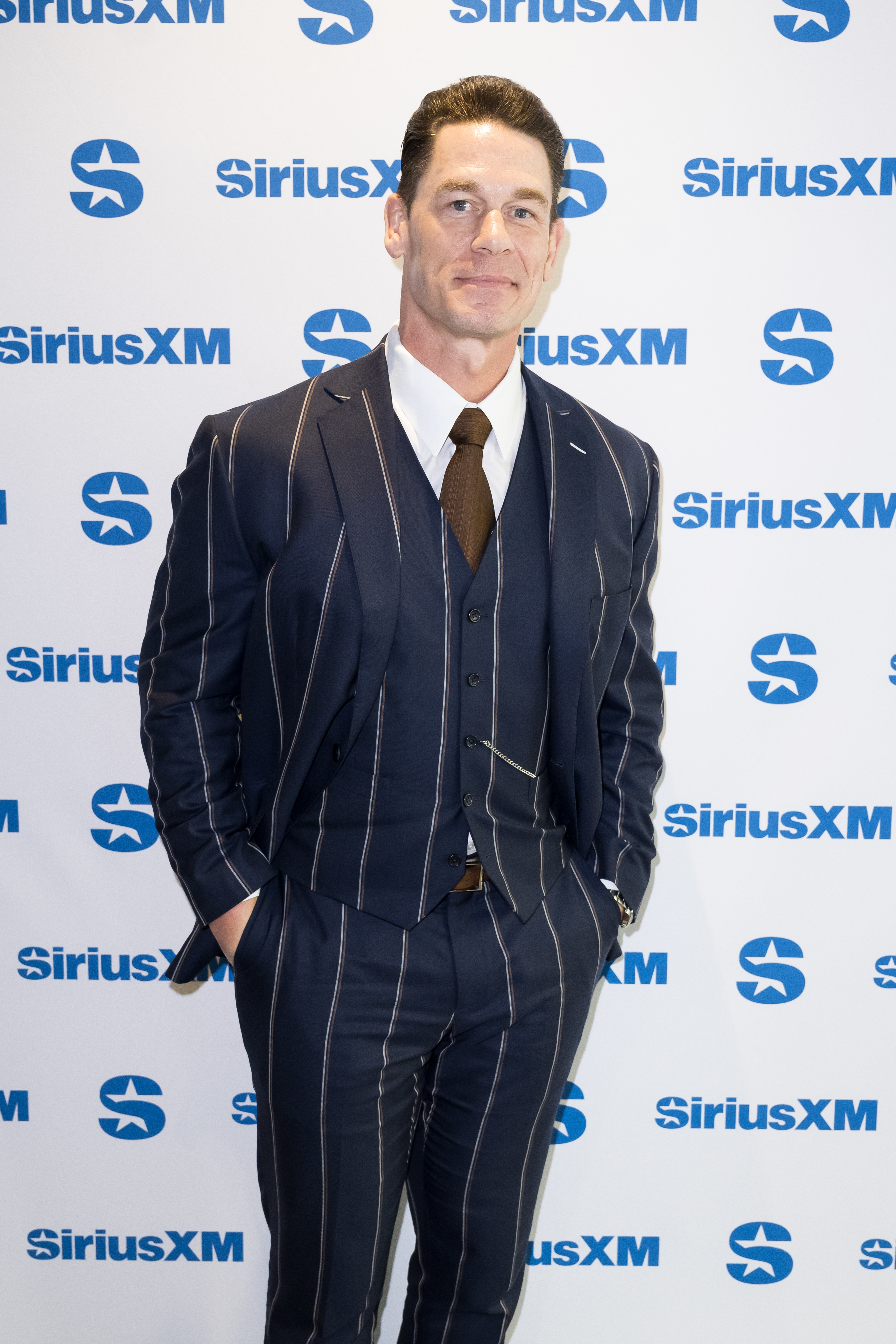 Closeup of John Cena on the red carpet in a striped suit