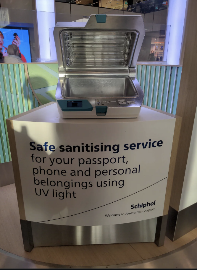 Sanitizing station for personal items with UV light at Schiphol Airport