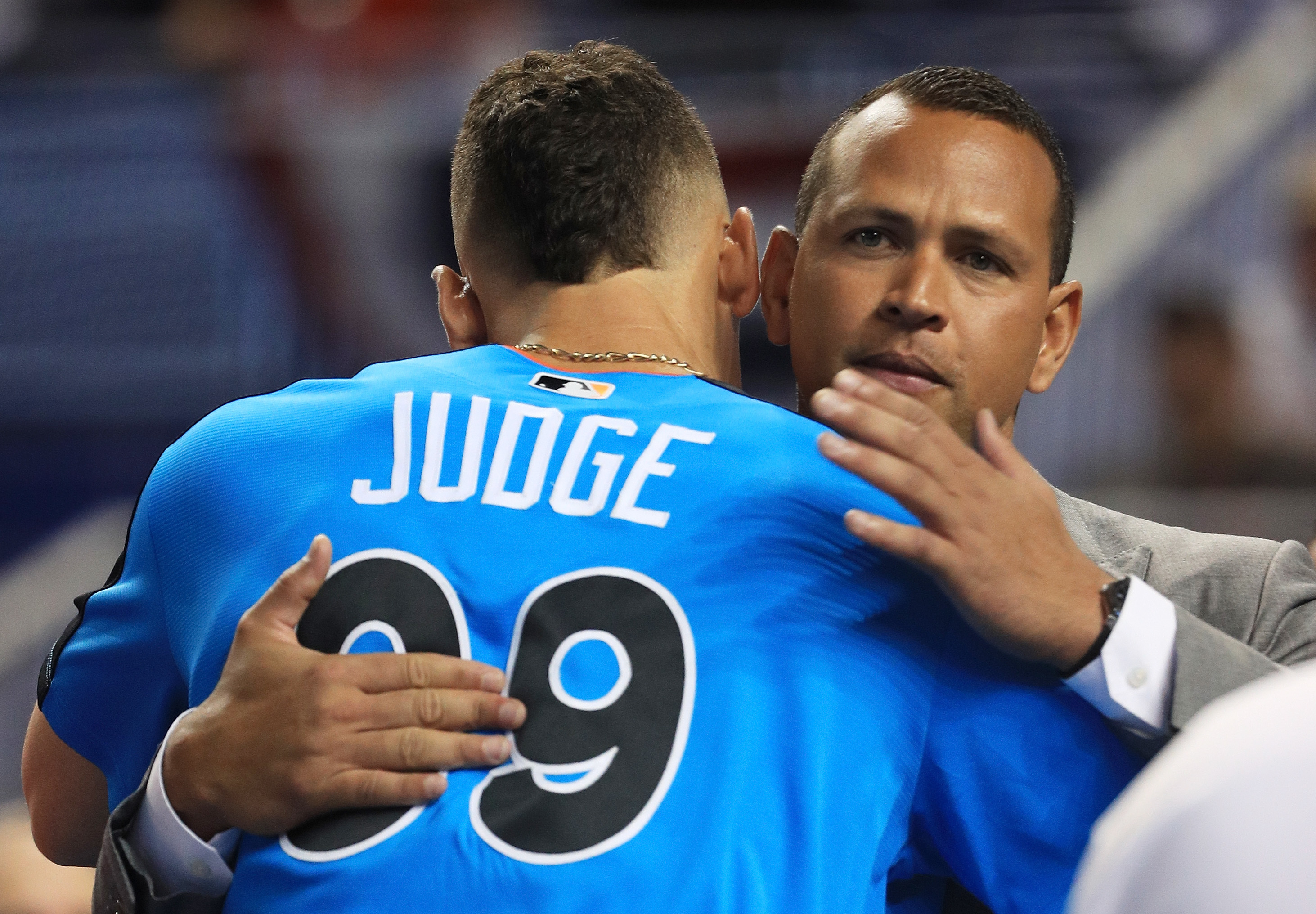 Two baseball players embracing on the field; one with &#x27;JUDGE 99&#x27; on his jersey