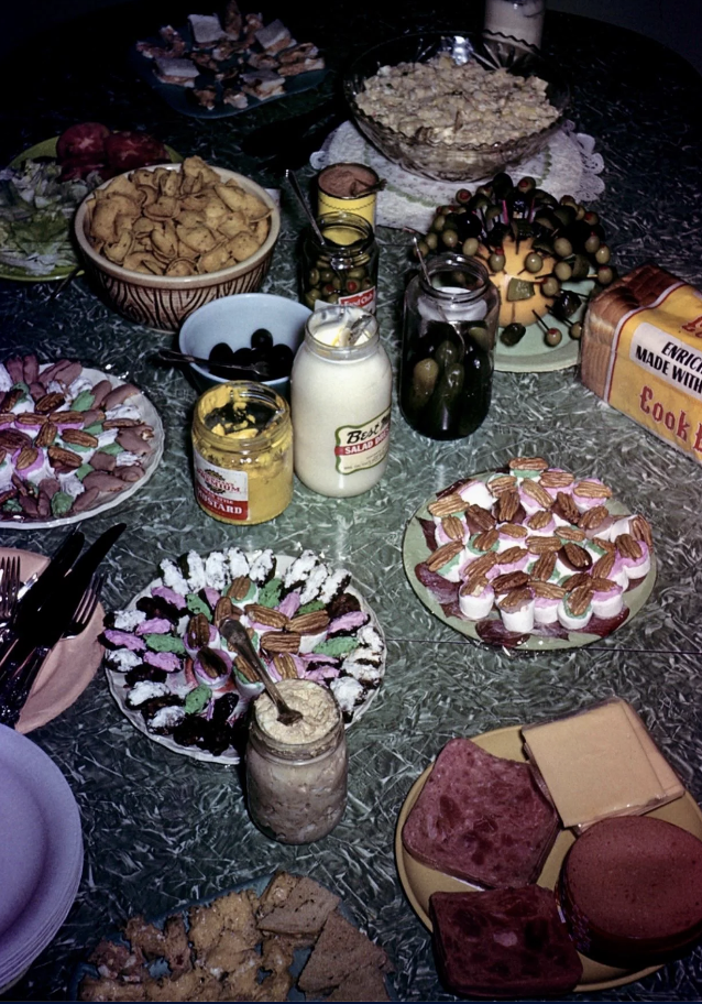 Assorted snacks and condiments spread on a table for a gathering