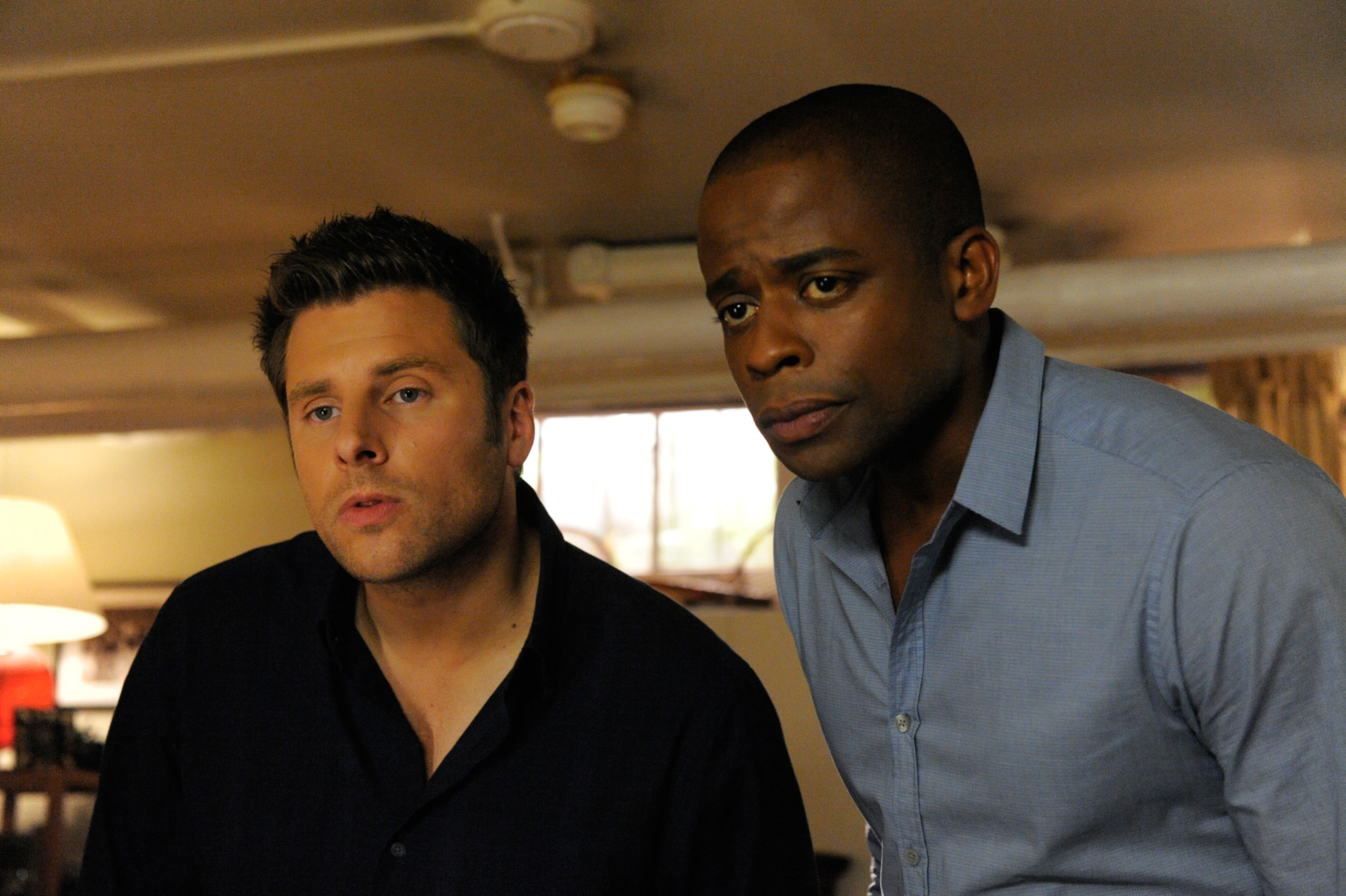 Two actors portraying Shawn and Gus from the TV show &quot;Psych&quot; look off-screen with concerned expressions