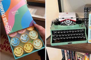 Someone is holding a package of "Shower Steamers" with smiley faces next to a lego typewriter and books