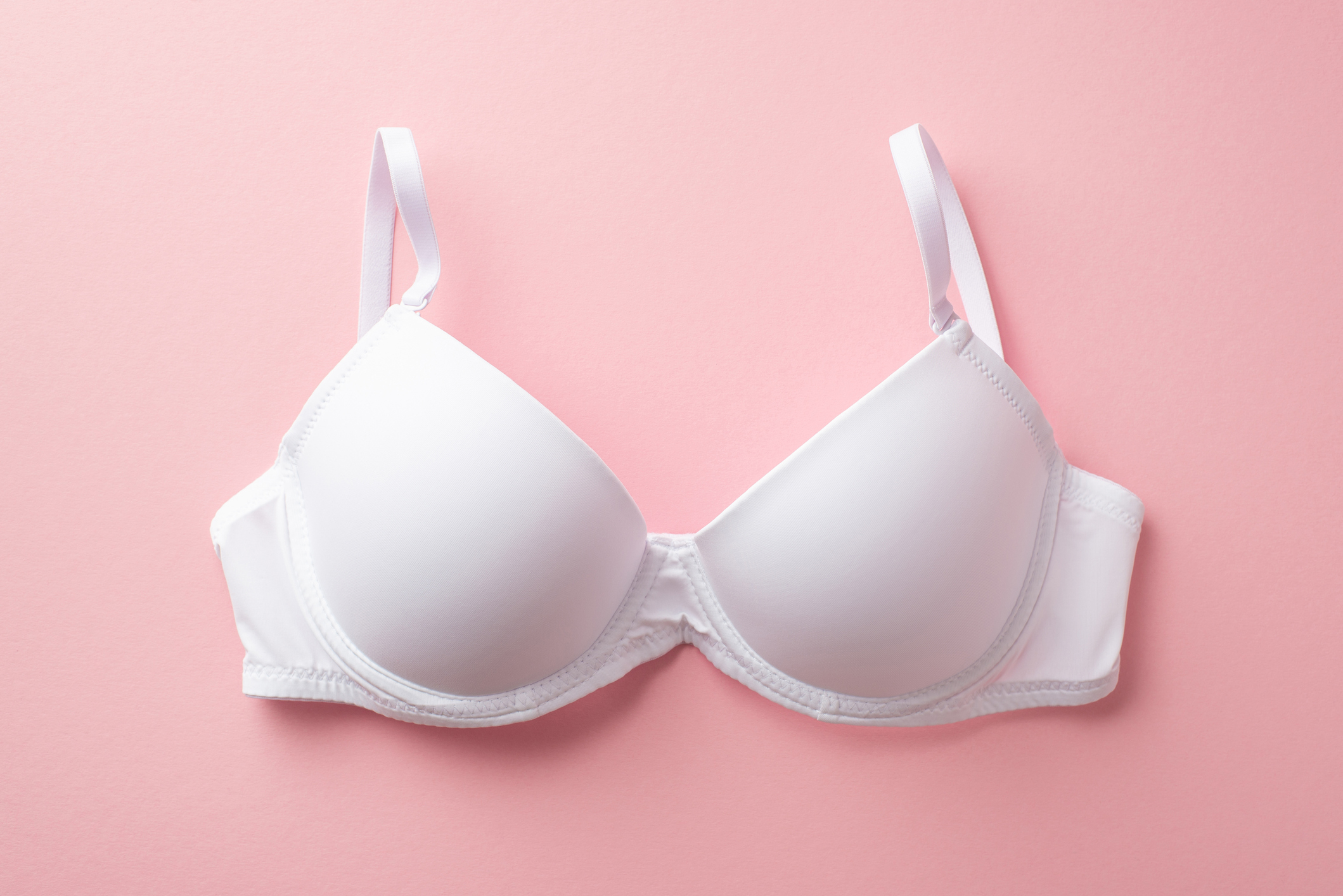 White bra against a pink background, related to a sex and love article topic