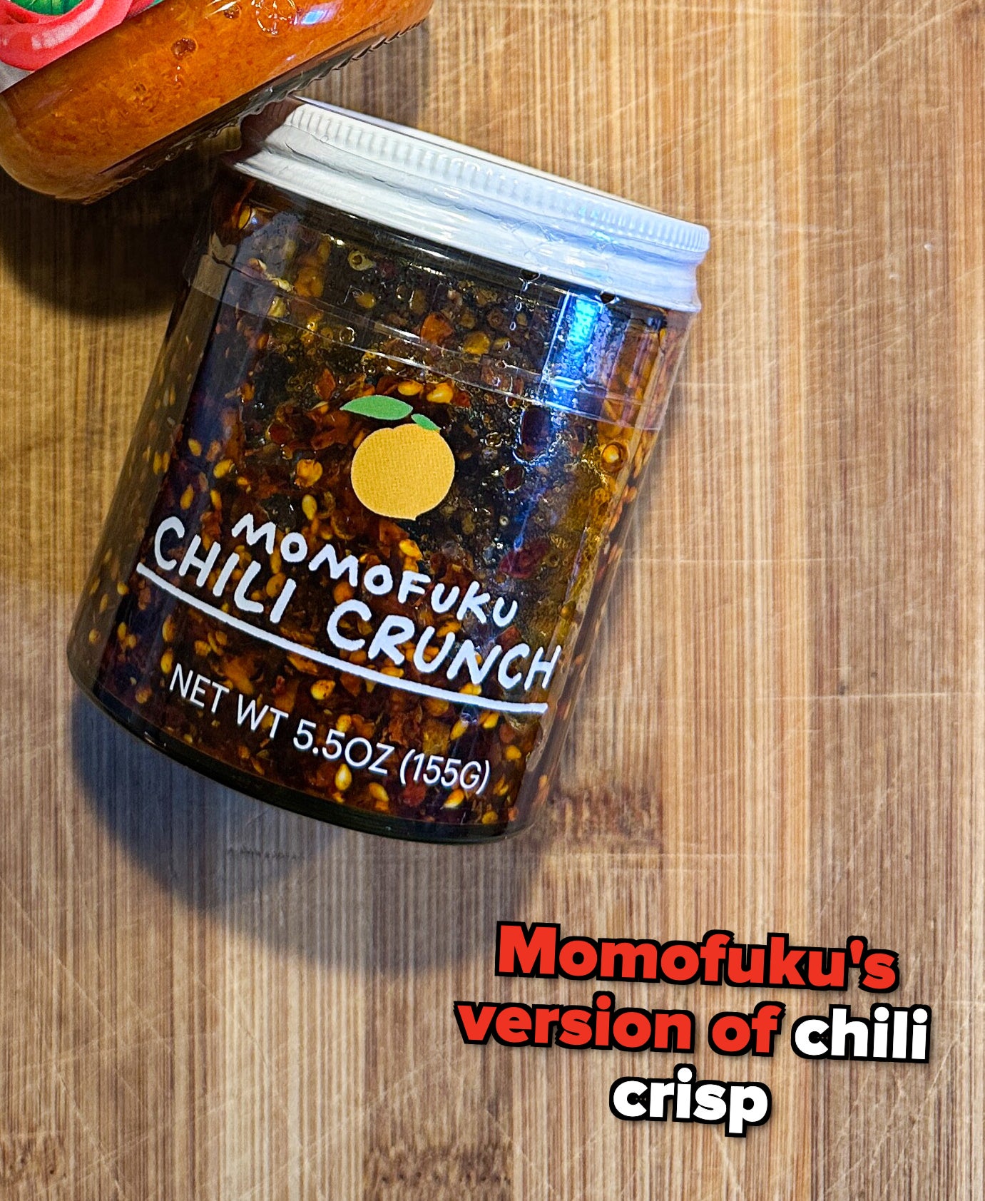 Chili crunch sauce on a wooden surface