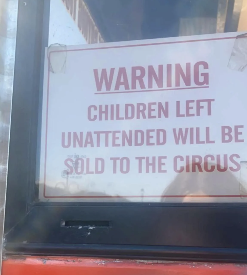 Humorous warning sign stating unattended children will be sold to the circus