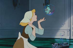 Cinderella, animated, gently sends a bubble with miniatures of herself and the Fairy Godmother floating inside it