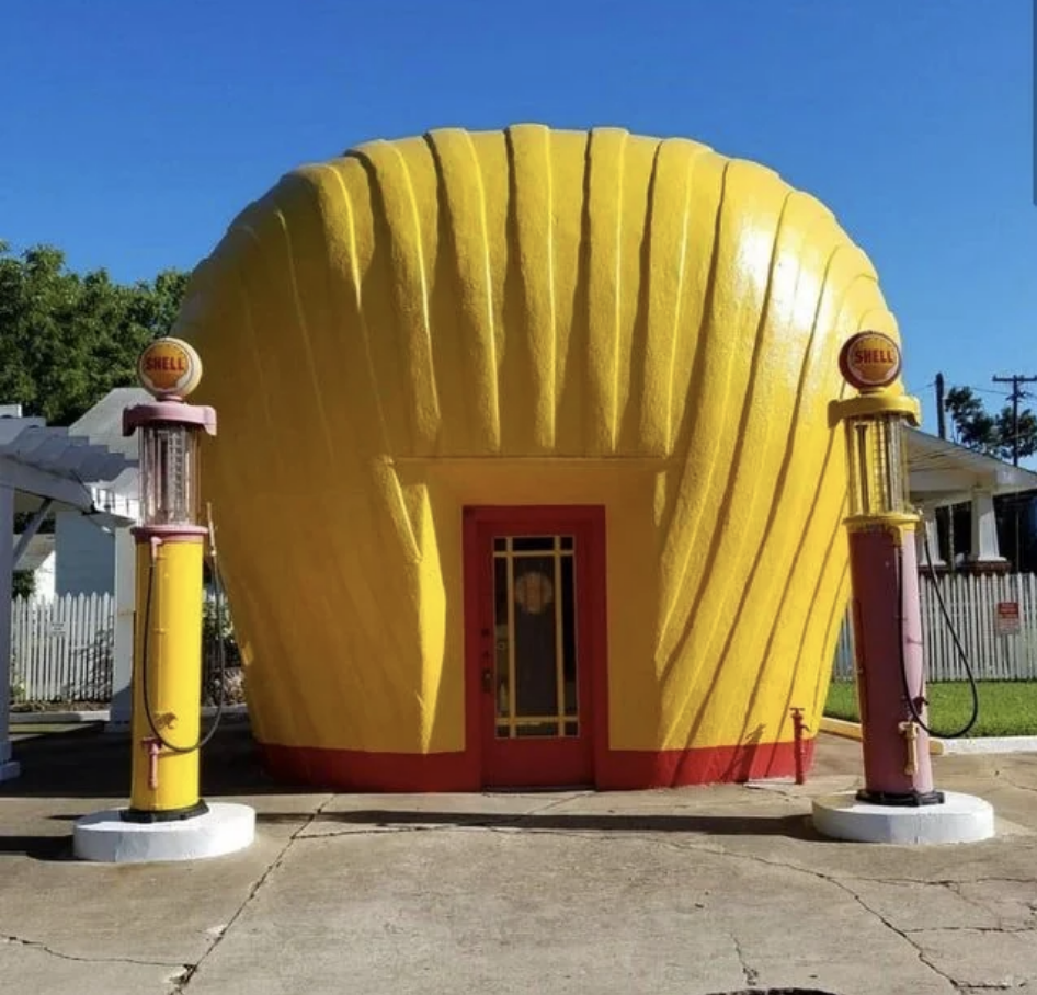 Shell-shaped gas station with two vintage pumps out front