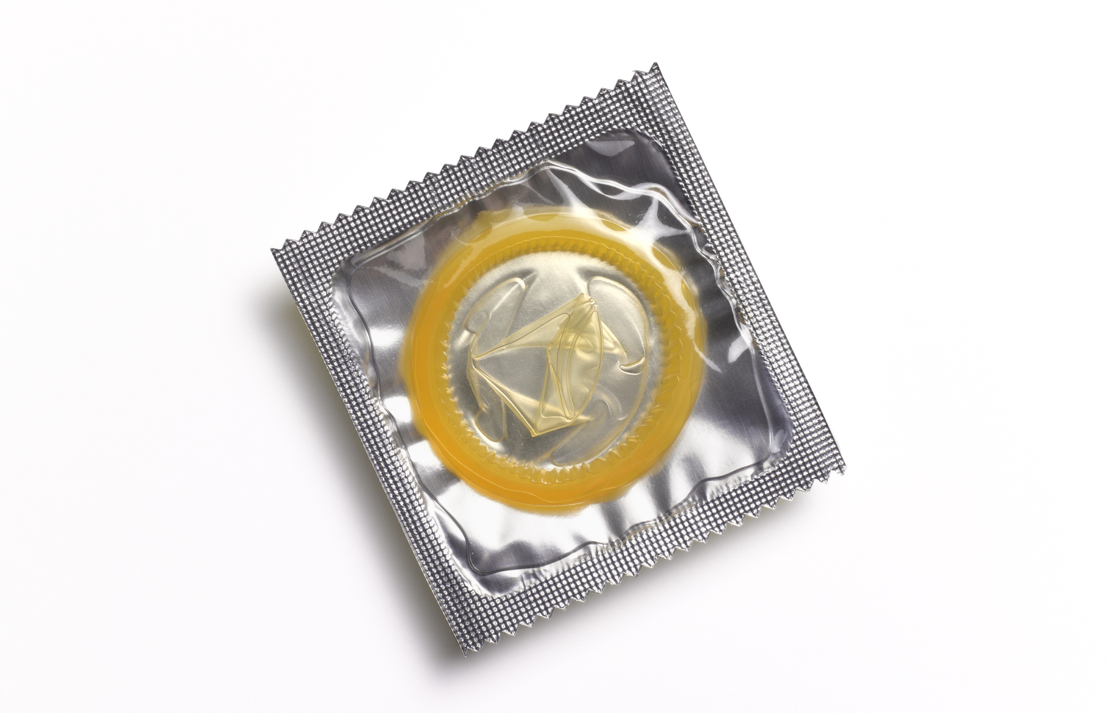 A wrapped condom isolated on a white background