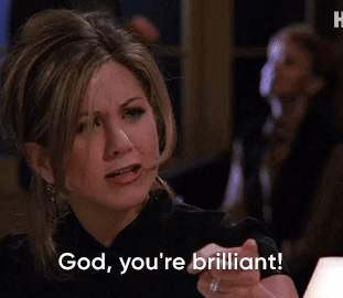 gif of Rachel from Friends in a dark top expresses admiration with a hand gesture that reads god. you&#x27;re brilliant