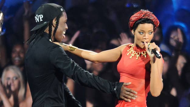 Two performers on stage; Rihanna in red with a headset mic, ASAP Rocky in black with cap, engaging with the audience