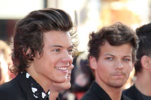 Harry Styles and Louis Tomlinson on the red carpet, Styles in a patterned shirt with a blazer, Tomlinson in plain tee and blazer