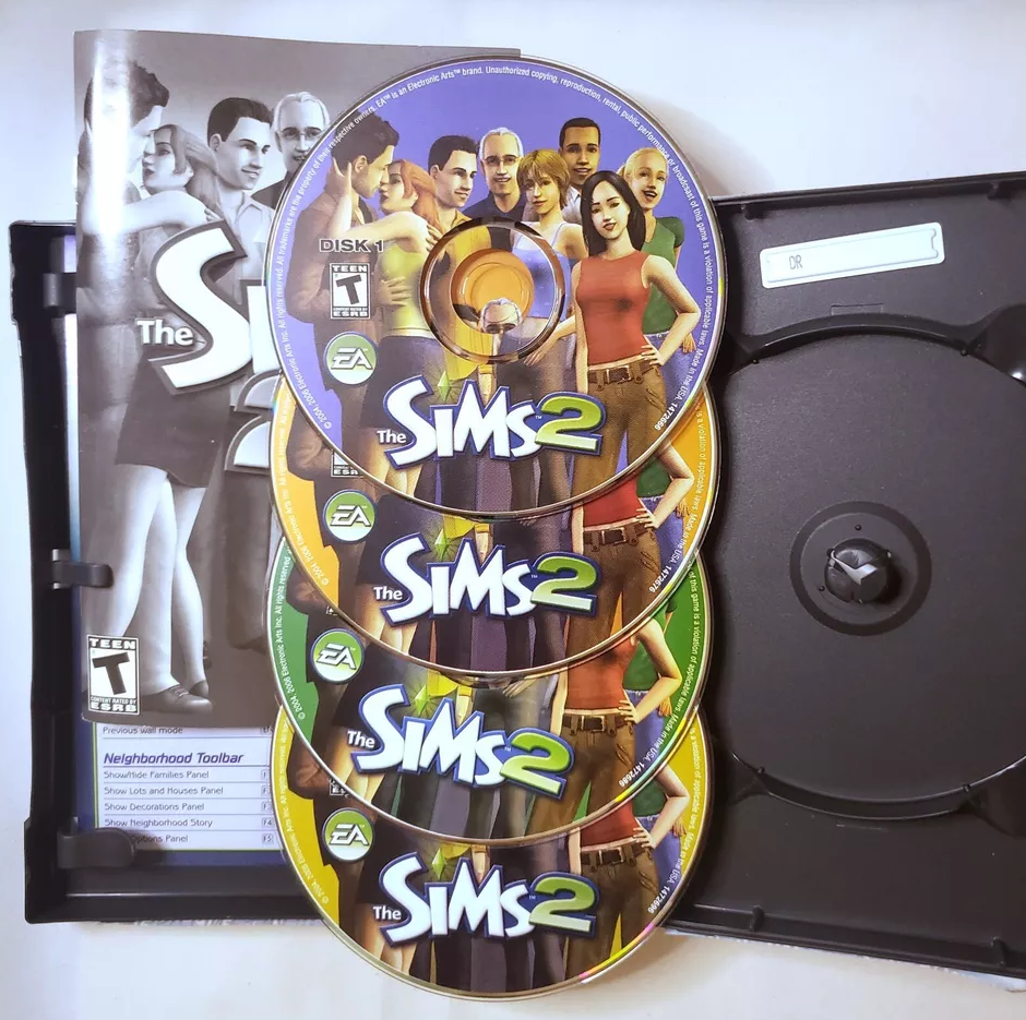 &quot;The Sims 2&quot; video game CDs and case with characters displayed on the cover and discs