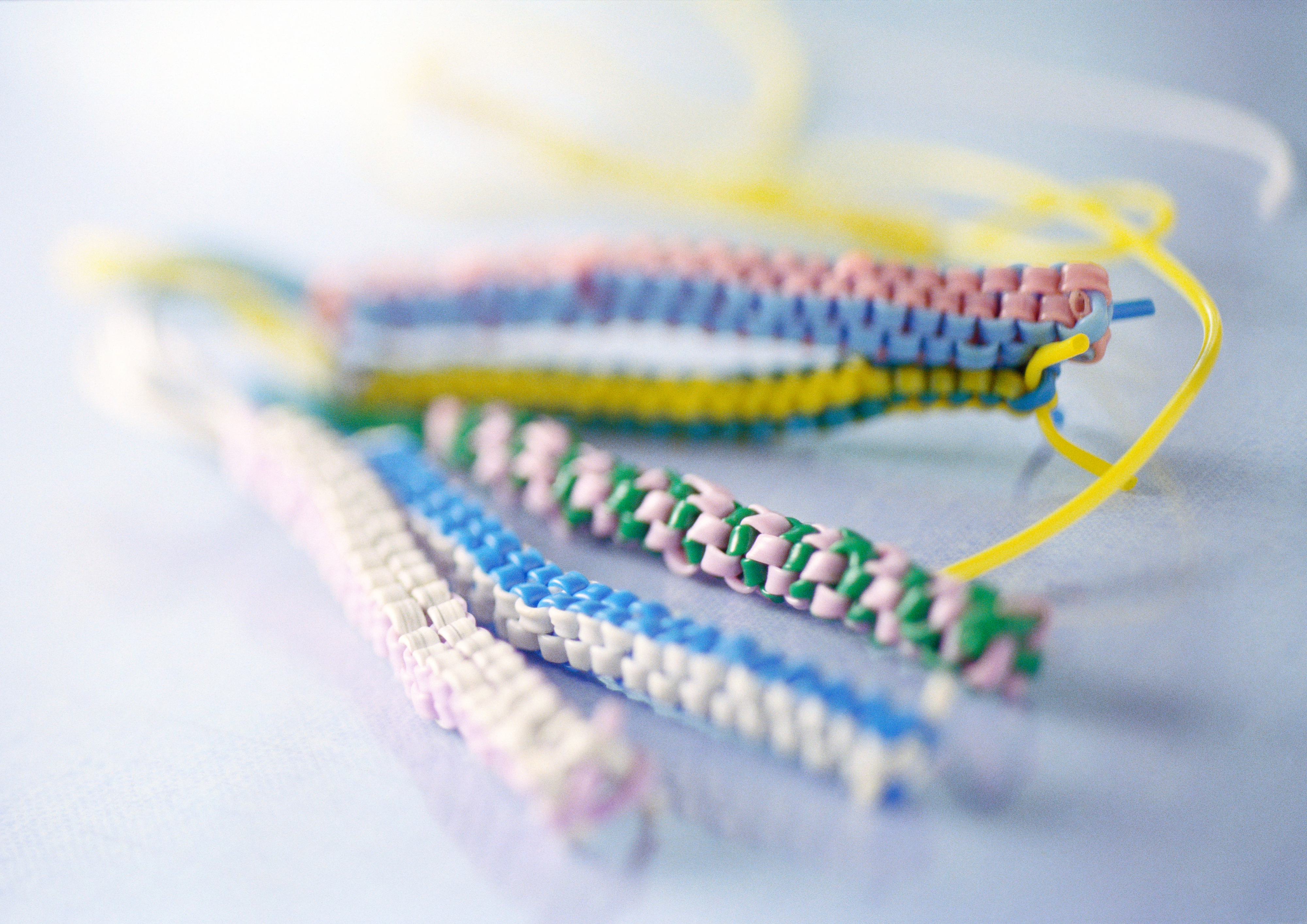 Handmade bracelets with various patterns on a surface