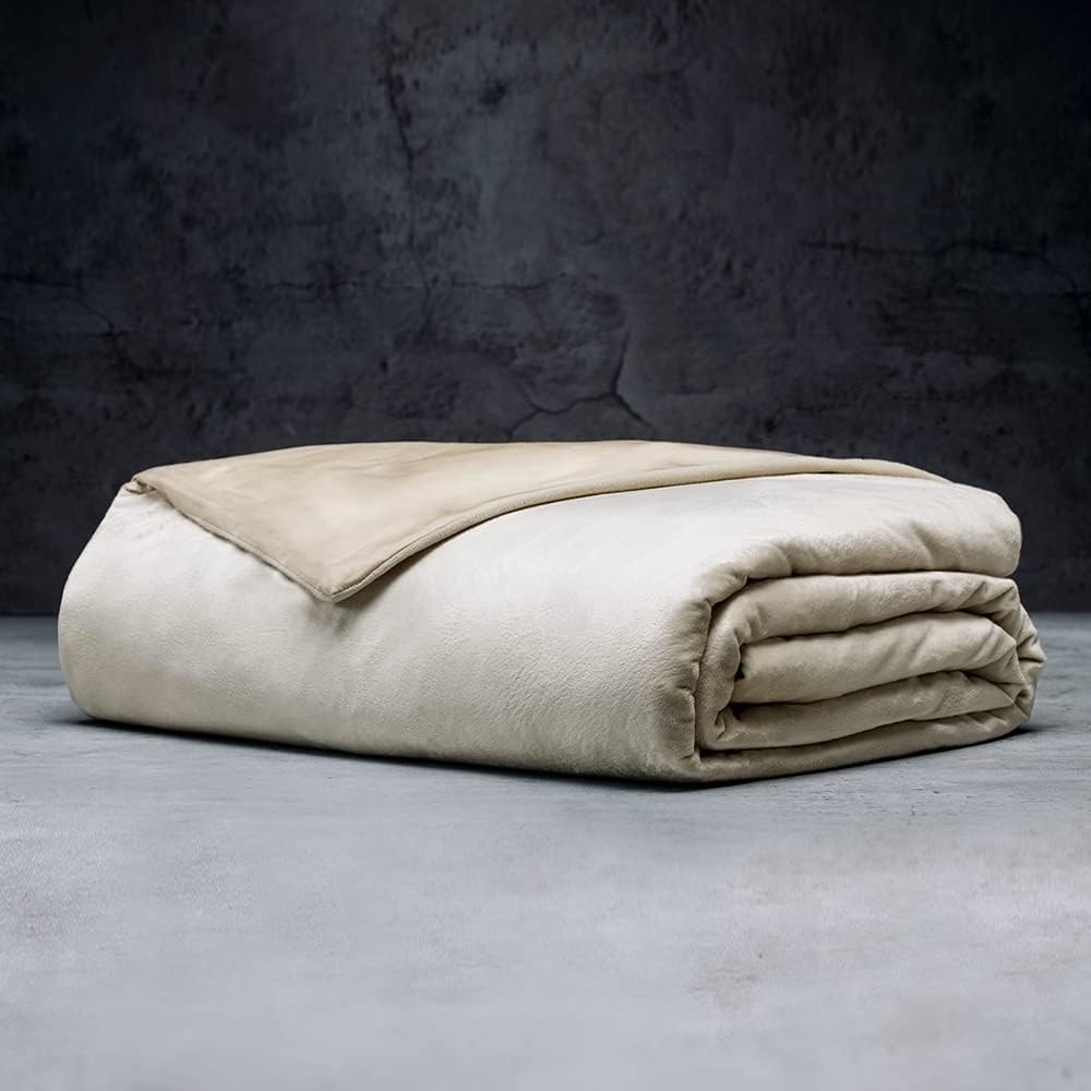 Folded beige blanket on a textured background