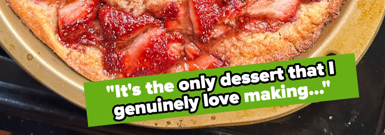 Freshly baked strawberry cake on a baking sheet with a quote about dessert