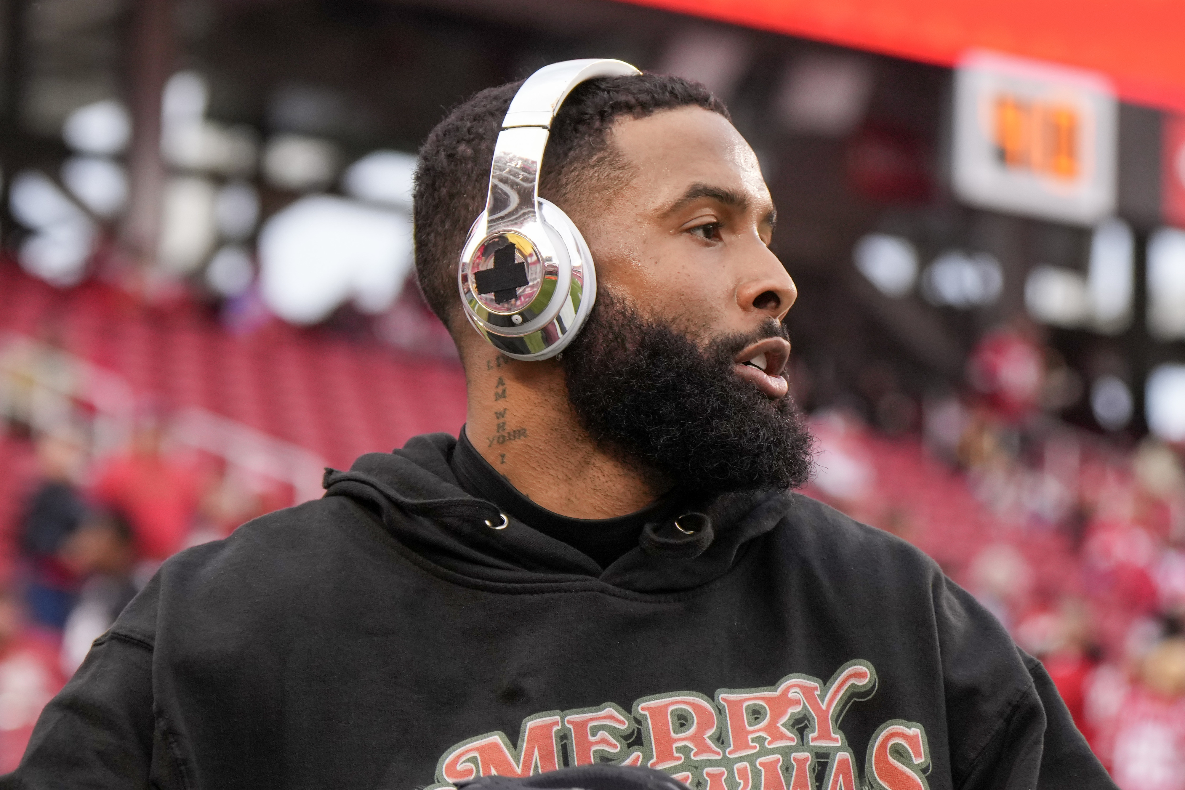 Odell Beckham Jr. wearing a black hoodie and headphones at a sports event