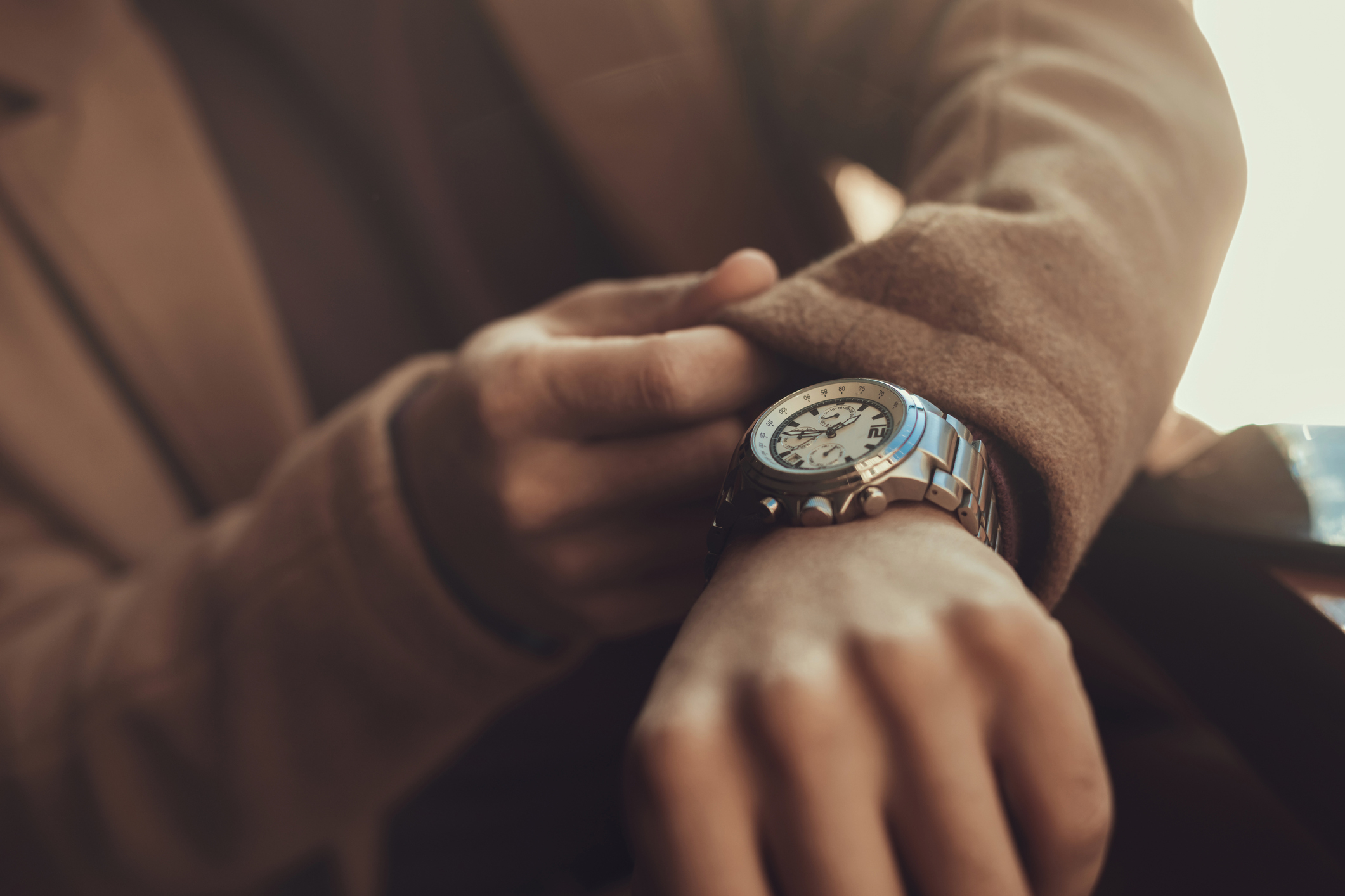 Close-up of a person fastening an elegant watch on their wrist