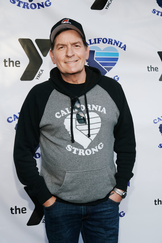 Charlie in a &quot;California Strong&quot; hoodie and cap posing at an event