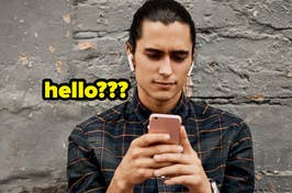 man looking at his phone with the text "hello???" by him