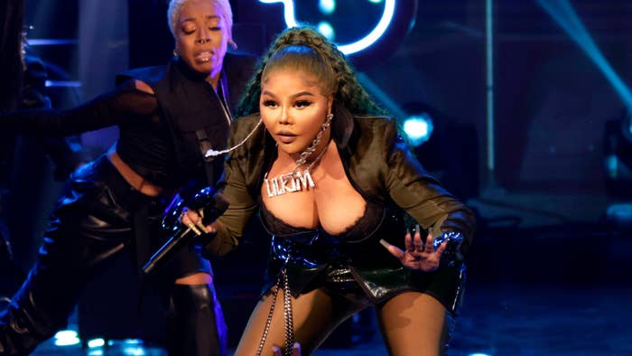 Lil&#x27; Kim performs on stage in a black outfit with backup dancer