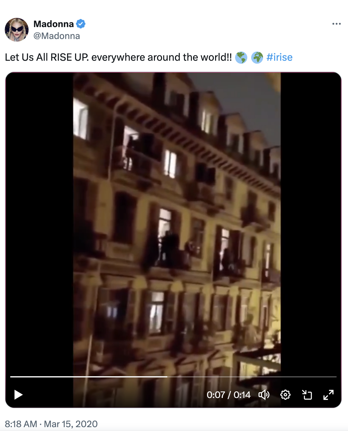 Tweet from Madonna encouraging unity with a video clip of people on apartment balconies at night. #Irise