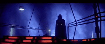 Darth Vader stands ominously on a bridge in a scene from Star Wars