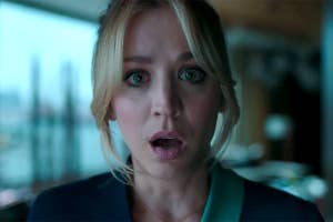 Kaley Cuoco with a surprised expression indoors, from "The Flight Attendant" on MAX