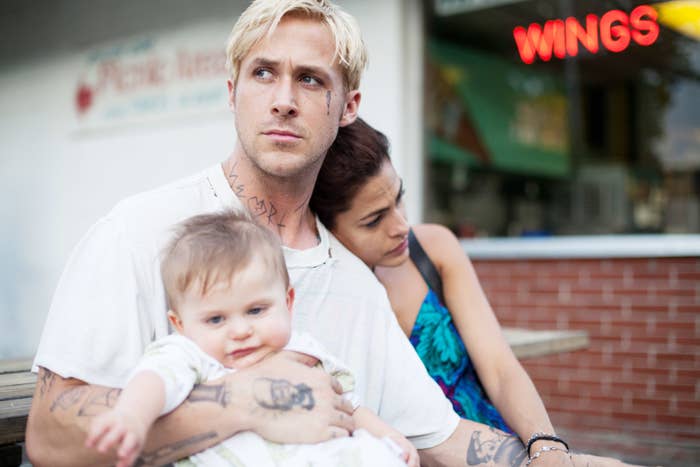 Ryan Gosling holding a baby, with Eva Mendes beside him, in &quot;The Place Beyond the Pines&quot;