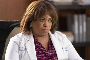 Chandra Wilson in character as Dr. Miranda Bailey wearing a lab coat with hospital ID