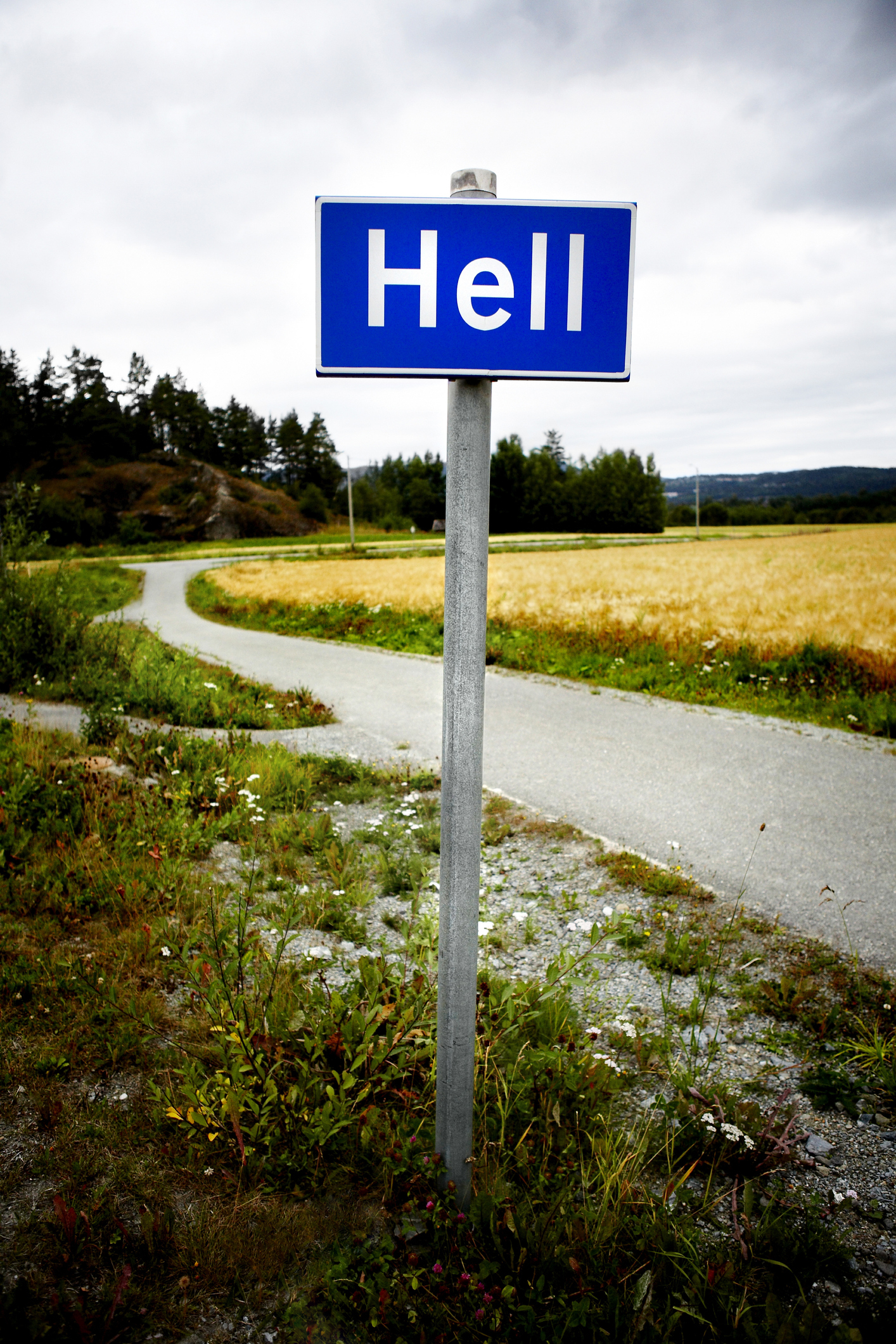 Signpost with the word &quot;Hell&quot; against a rural backdrop