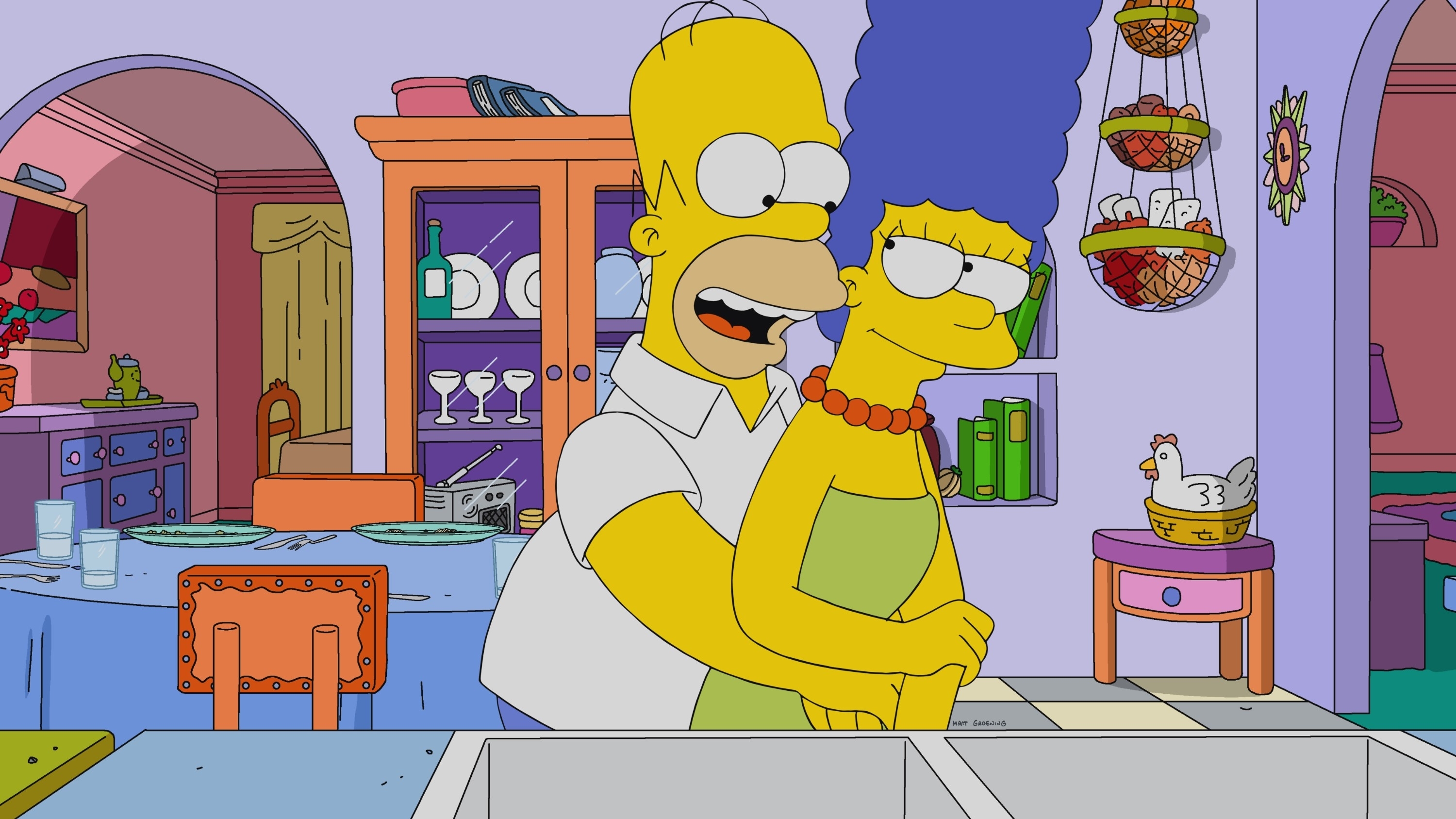 Homer and Marge Simpson in their kitchen with a smiling embrace