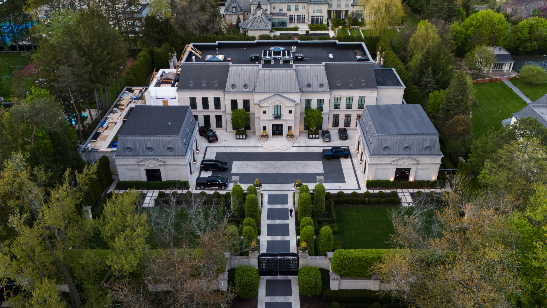 Aerial view of a large mansion with formal gardens, indicative of a celebrity&#x27;s residence, for a music article