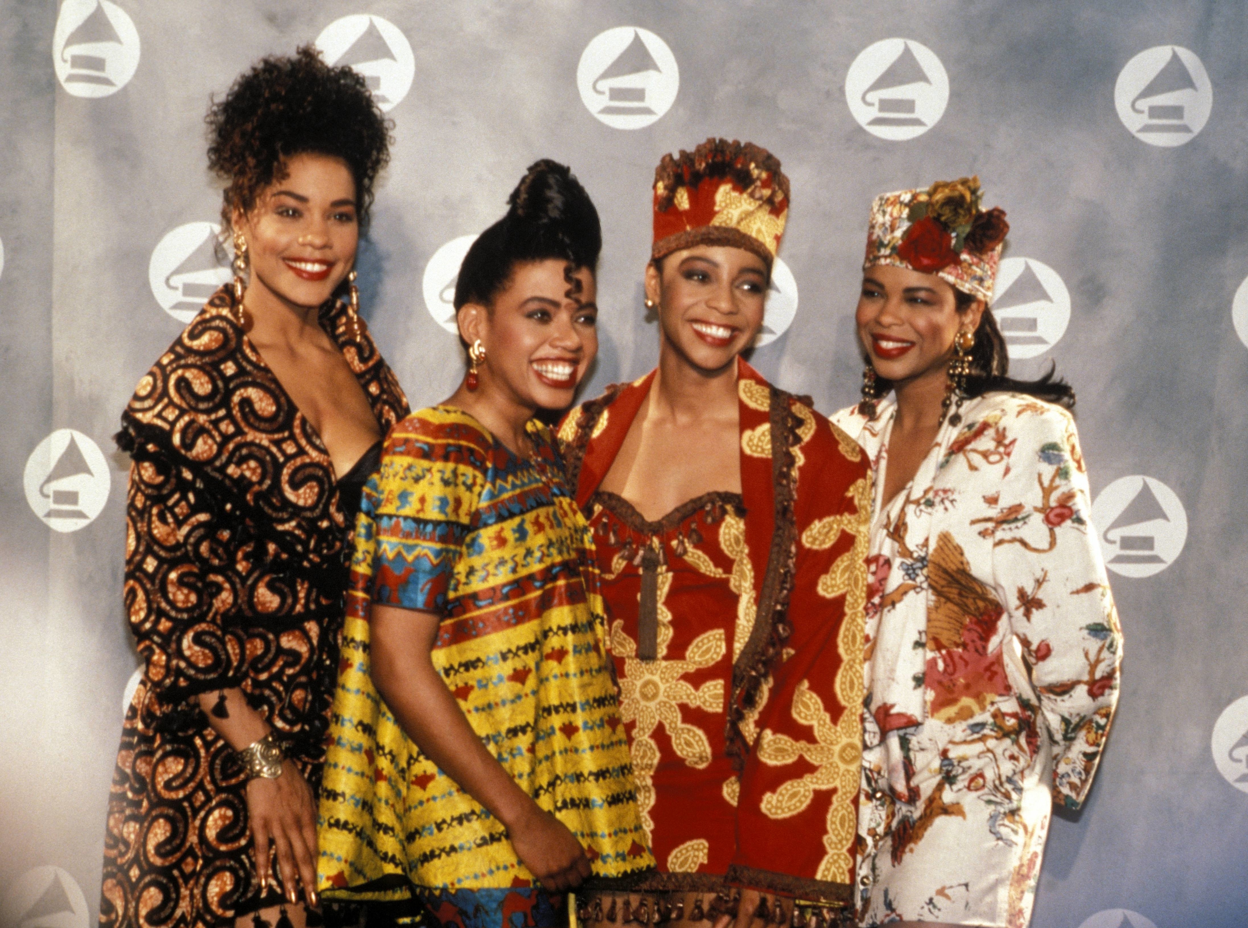 Four women at an event wearing vibrant traditional African-inspired attire