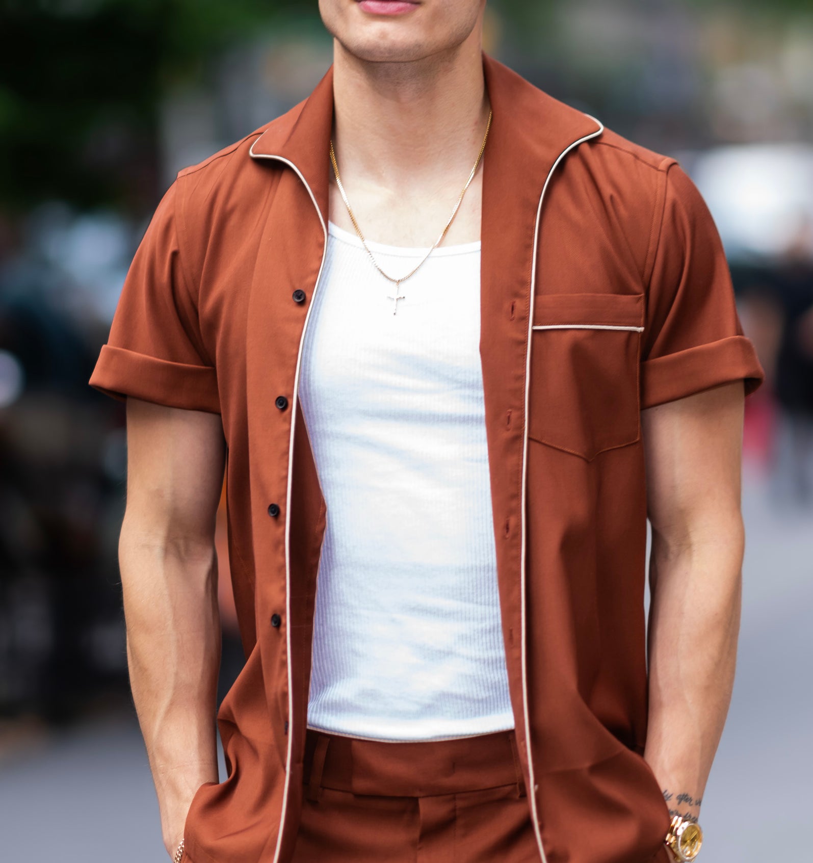 Matt Rife in monochrome outfit with open collared shirt, matching pants, and a tucked white T-shirt