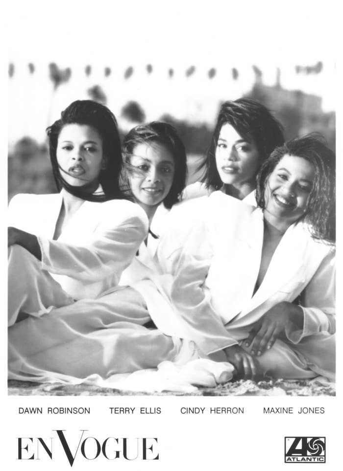 Four members of En Vogue posing, wearing white tops, with their names: Dawn Robinson, Terry Ellis, Cindy Herron, Maxine Jones