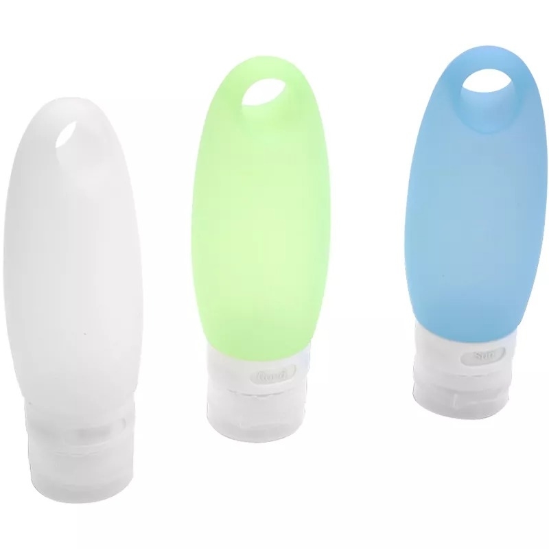 Three silicone travel bottles in white, neon green, and light blue