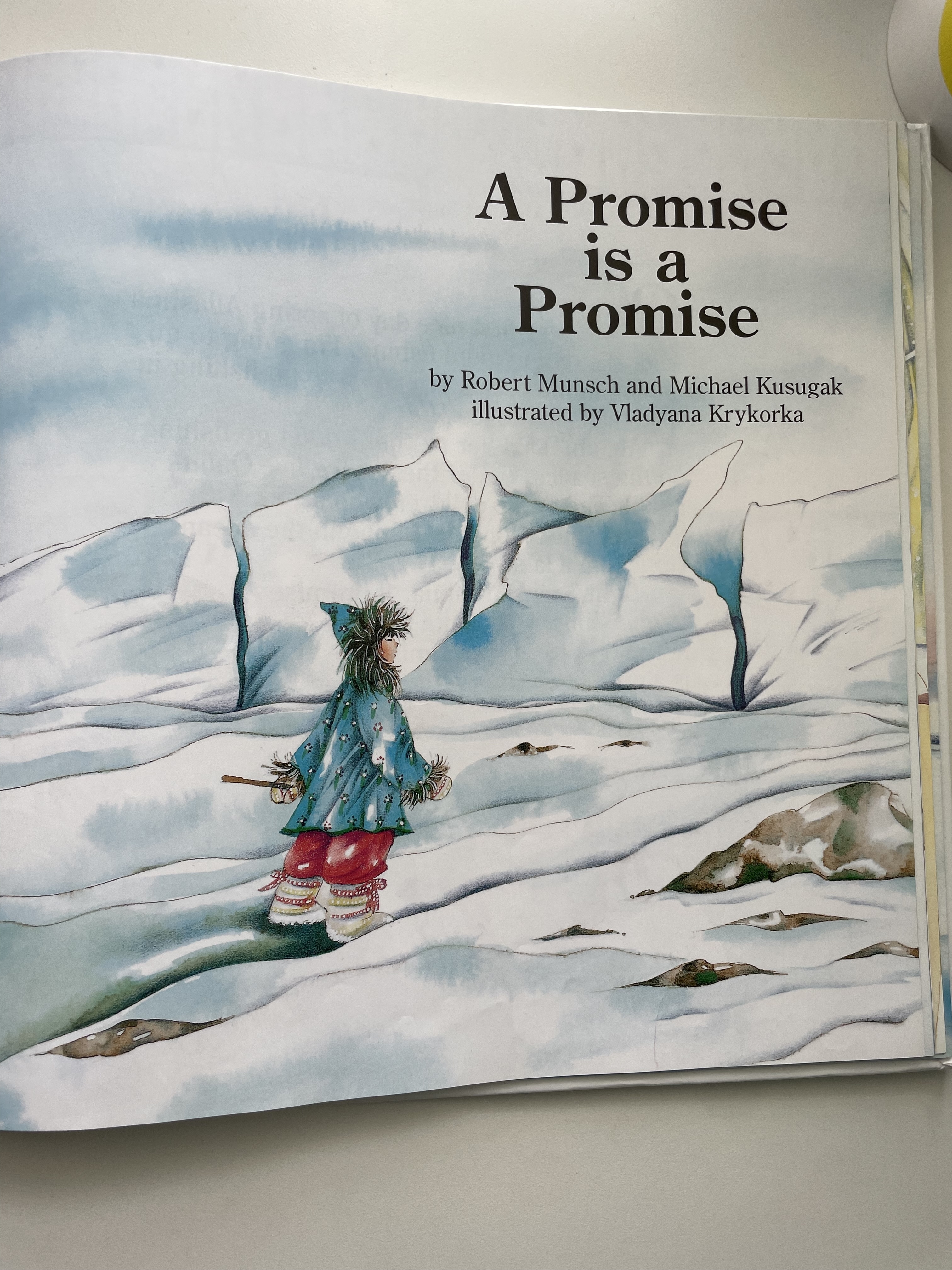 Book page titled &quot;A Promise is a Promise&quot; showing an illustration of a child in winter clothing against a snowy backdrop