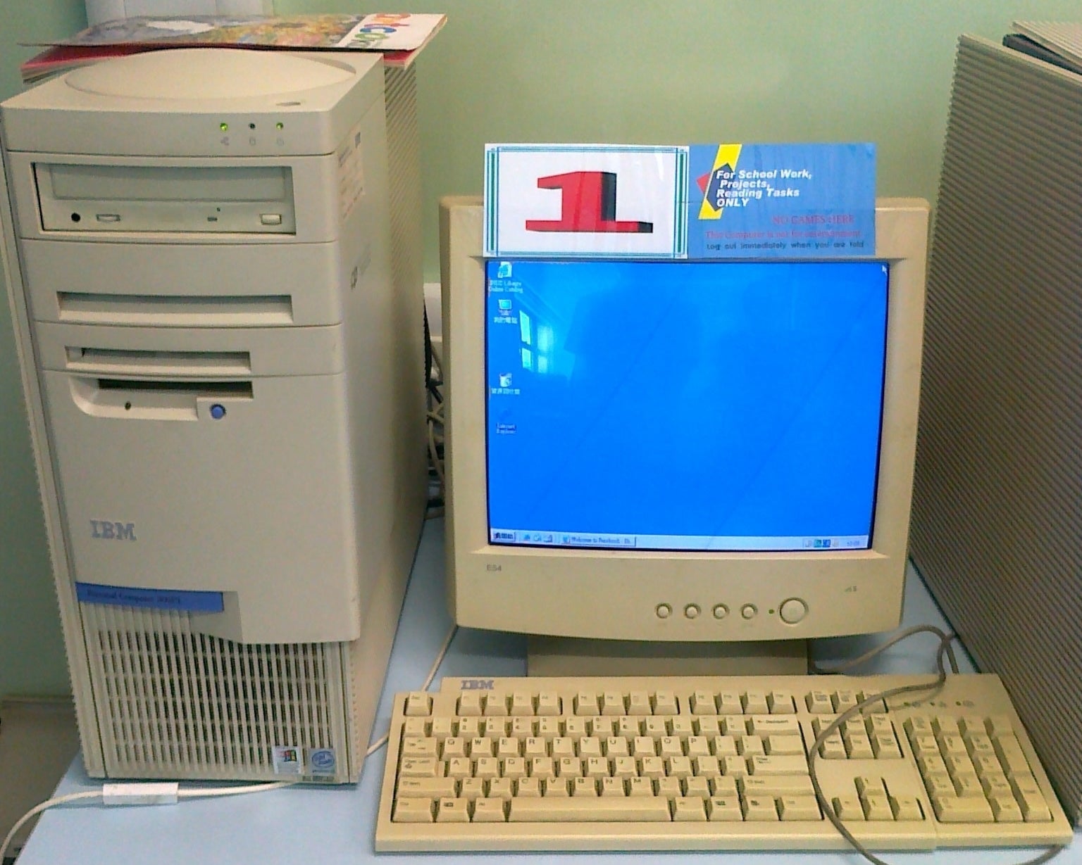 Vintage computer setup with monitor displaying desktop and tower unit beside it