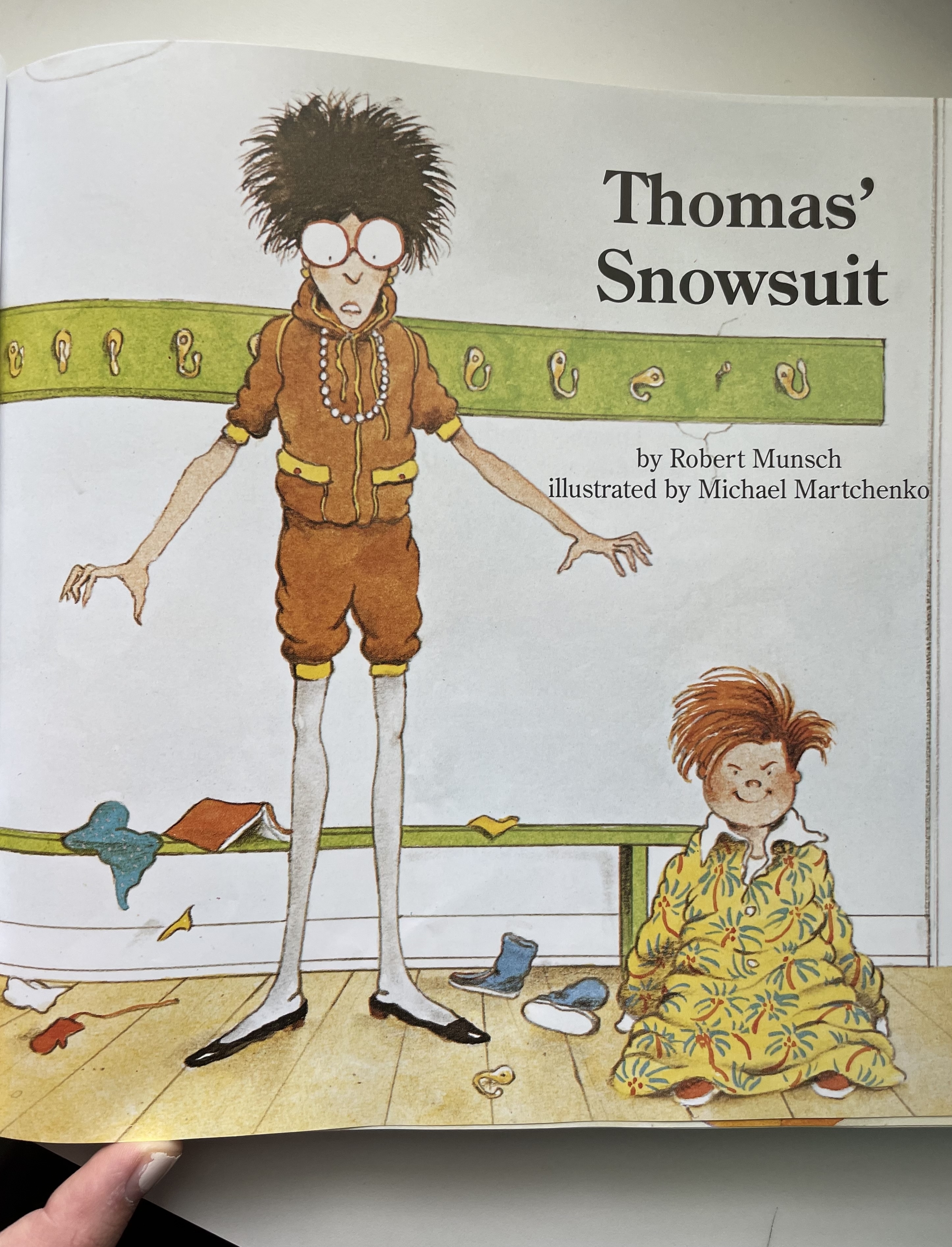 Illustration from &quot;Thomas&#x27; Snowsuit&quot; showing a child in a mismatched outfit and a smaller child looking on